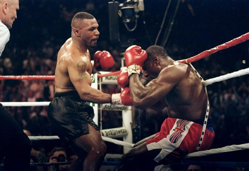 LAS VEGAS - MARCH 16:  (FILE PHOTO) Mike Tyson throws a punch at Frank Bruno during a fight at the MGM on March 16, 1996 in Las Vegas, Nevada.  On September 22, 2003, the former world heavyweight boxing champion was taken to psychiatric hospital for treatment.  It has been reported that Bruno was seeking help for depression as he struggled to come to terms with life outside the ring and a divorce.  (Photo by Al Bello/Getty Images)  