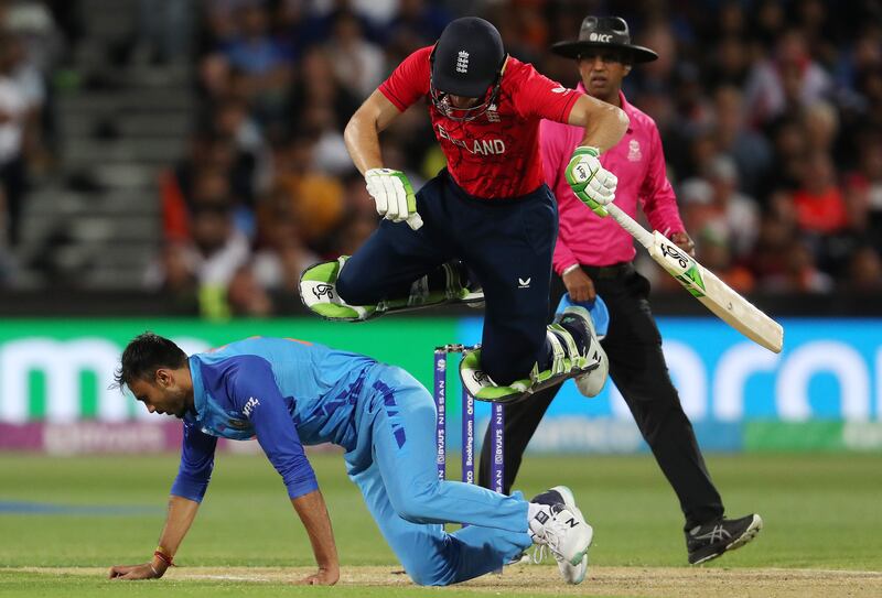 England captain Jos Buttler takes evasive action to avoid Axar Patel of India. Getty