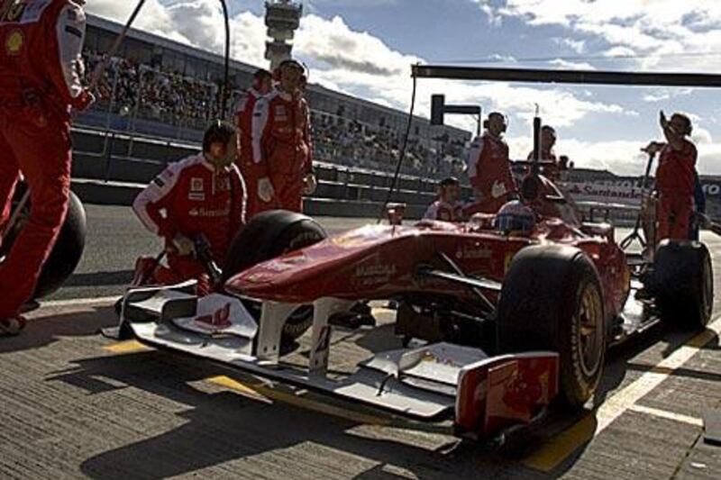 Fernando Alonso with members of the Ferrari team during a testing session in Spain.