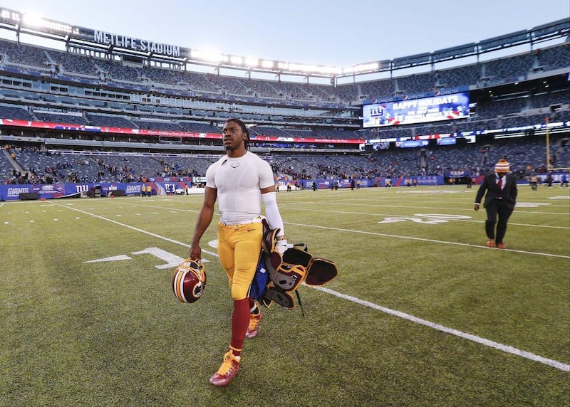Washington quarterback Robert Griffin III walks off the field after his team's loss to the New York Giants in the NFL on Sunday. Julio Cortez / AP / December 14, 2014 