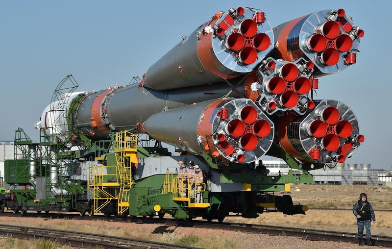The Soyuz- FG carrier trundles along the back of a train close to the Russian-run Baikonur Cosmodrome in rural Kazakhstan ahead of the launch on Wednesday evening. Vyacheslav Oseledko / AFP