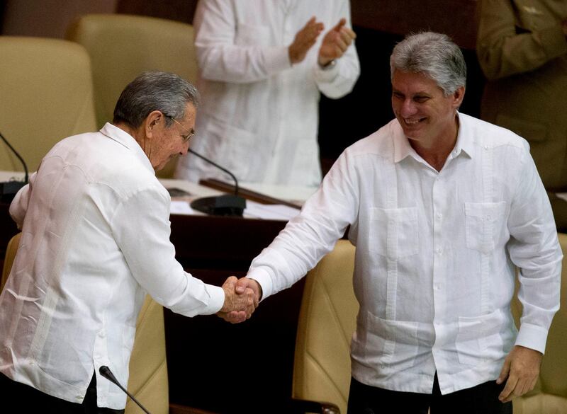 FILE - In this Dec. 20, 2014 file photo, Cuba's President Raul Castro, left, shakes hands with Vice President Miguel Diaz-Canel, at the closing of the legislative session at the National Assembly in Havana, Cuba. Cuban state media reported Monday, April 16, 2018, that the government has moved up the start of a session of the National Assembly in which Castro plans to step down and is expected to pass the presidency to the 57-year-old vice president. The session will now start Wednesday, April 17. (AP Photo/Ramon Espinosa, File)