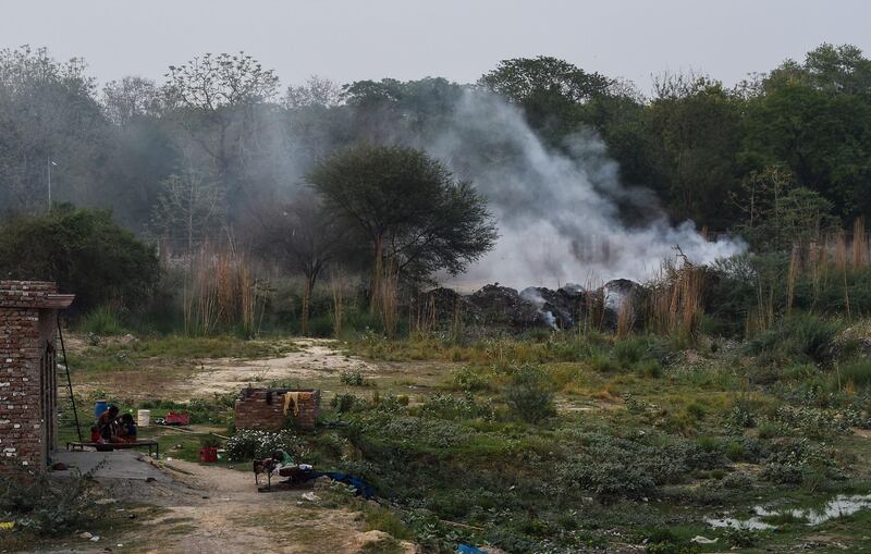 Smoke rises from a burning field near the industrial area in the Indian city of Kanpur. The city of three million people has been smarting since a World Health Organisation (WHO) report last month put Kanpur at the head of 14 Indian cities in the world's top 15 with the dirtiest air. Chandan Khanna / AFP
