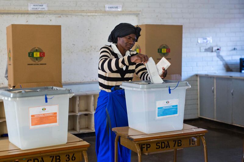 A Zimbabwean woman casts her vote for the presidential elections at the Fitchela primary school in Kwekwe, Zimbabwe. AP Photo / Jerome Delay