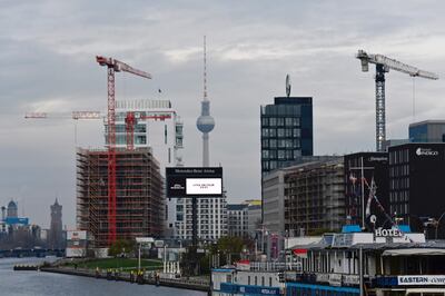 Cranes are seen at a constructions site of buildings in proximity to the Berlin Town Hall (back L), the Television Tower (back C) and the river Spree in the centre of Berlin on December 4, 2020. / AFP / Tobias Schwarz
