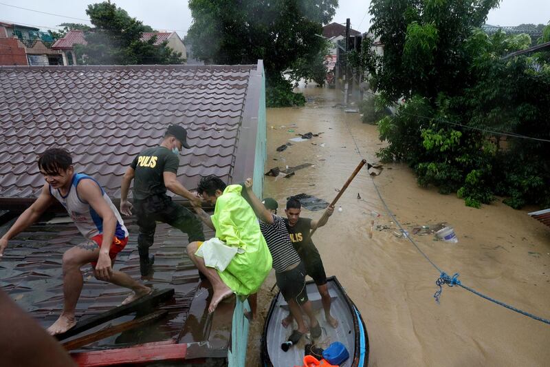 Police rescue residents as floods continue to rise in Marikina. AP Photo