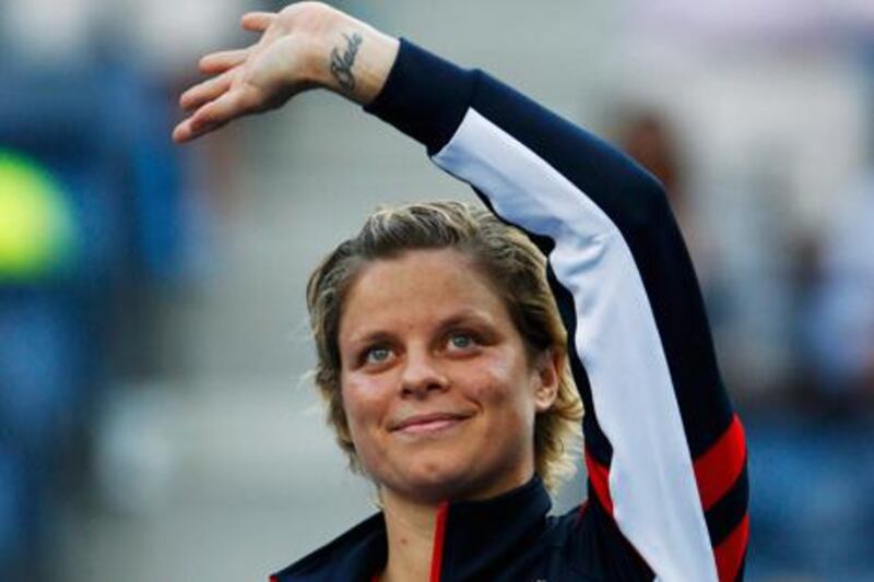 Kim Clijsters waves goodbye to fans at the US Open after her defeat to Laura Robson