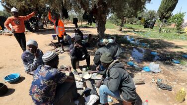 Sub-Saharan African migrants cook at a camp in Jebeniana, in Tunisia's Sfax province. Sfax is one of the main departure points for irregular migration to Europe. EPA