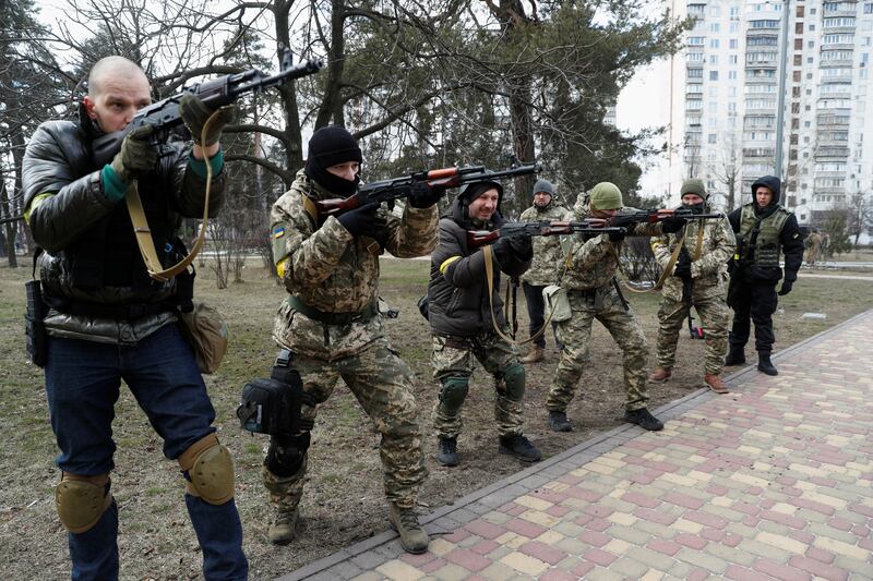 An instructor conducts a military exercise for new members of the Territorial Defence Forces in Kyiv. Reuters