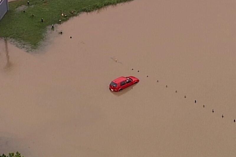 This image from a video shows a submerged car on Gold Coast, Australia. AP