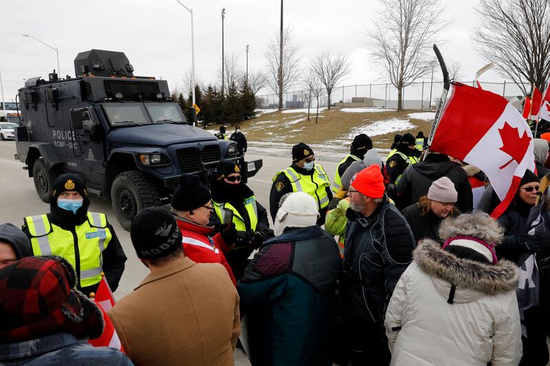Protesters against Covid-19 vaccine mandates are stopped by police as they block the entrance to the Ambassador Bridge in Windsor, Ontario, Canada. AFP.