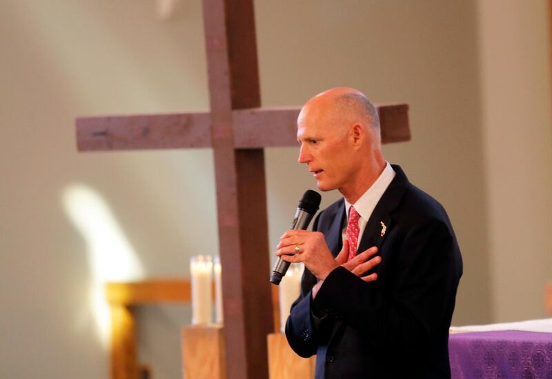 Florida Governor Rick Scott addresses the congregation during a Sunday service at the First United Methodist Church of Coral Springs, dedicated to the victims of the Wednesday mass shooting at nearby Marjory Stoneman Douglas High School, in Coral Springs, Fla., Sunday, Feb. 18, 2018. Nikolas Cruz, a former student, who is in custody, was charged with 17 counts of murder on Thursday. (AP Photo/Gerald Herbert)