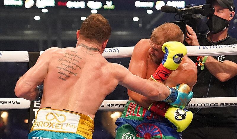 Billy Joe Saunders blocks a body shot from Saul Alvarez during their unified super middleweight world title fight. AP