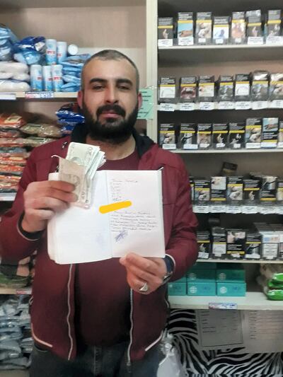 An Ankara grocery store owner shows the credit book and the debts paid off by CHP deputy and pharmacist Gamze Tascier. Courtesy Gamze Tascier