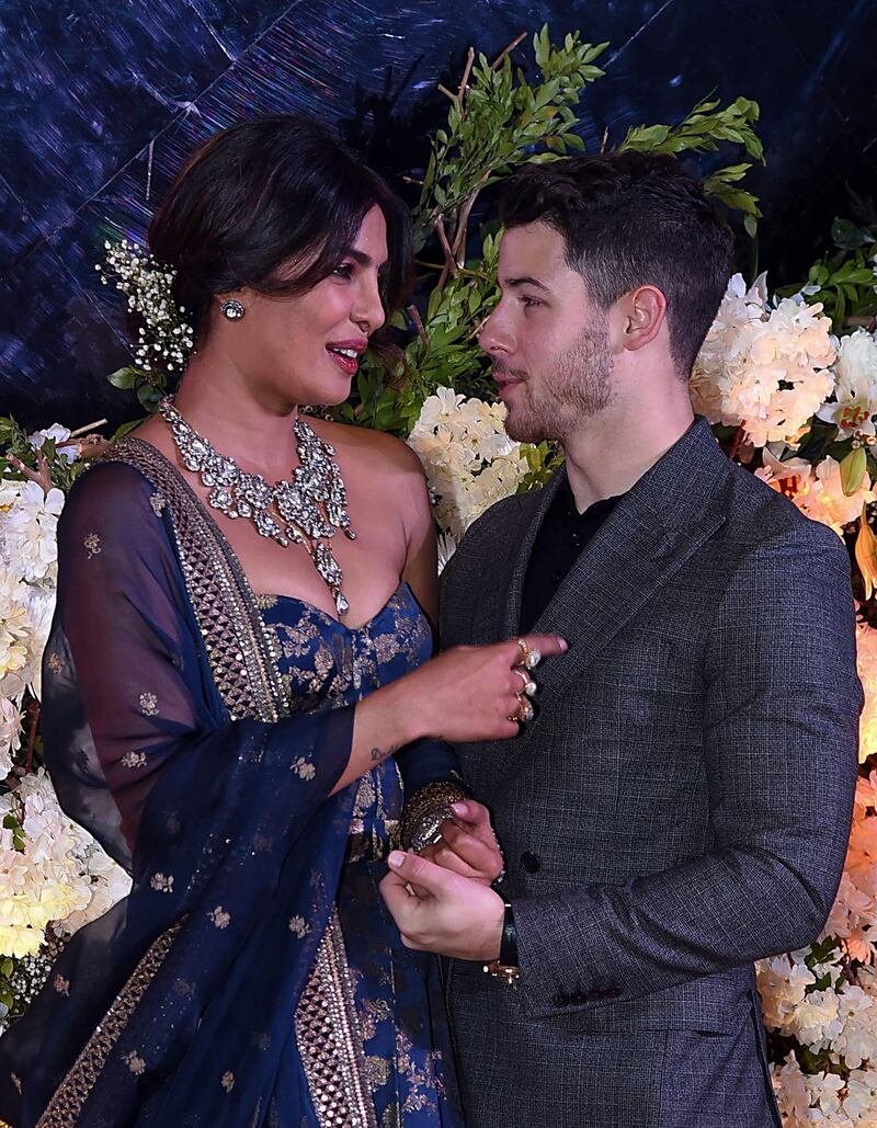 The newlyweds looked happy as they praised each other in speeches at the start of the reception / AFP / Sujit Jaiswal