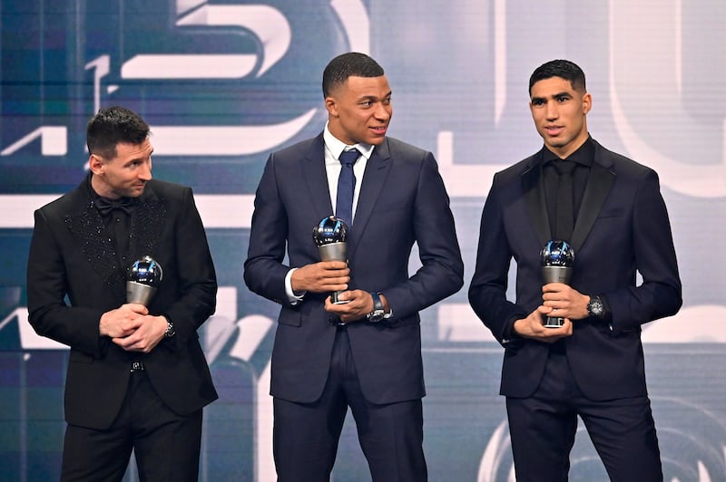 Lionel Messi, Kylian Mbappe and Achraf Hakimi are seen with their trophies after being included in the Fifa Fifpro Men's World 11 2022 squad. Getty 