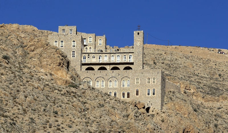 A picture shows a view of Deir Mar Moussa Al-Habashi (St Moses the Ethiopian monastery),  one of the ancient monasteries in Syria in the mountains near the desert in the Nabek area in Damascus countryside, on June 11, 2022.  - A Syrian desert monastery that was once a hub for interfaith dialogue, attracting tens of thousands, has reopened to visitors after more than a decade of war and isolation.  (Photo by LOUAI BESHARA  /  AFP)
