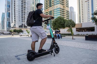 DUBAI, UNITED ARAB EMIRATES. 26 OCTOBER 2020. E-scooter trials rolled out in five areas across city for a year long project for commuters to rent and use e-scooters while commuting to and from tram and metro stations. A resident who did not want to give his name checks out one of the scooters for rent at the DMCC Metro Station in JLT. (Photo: Antonie Robertson/The National) Journalist: Kelly Clarke. Section: National.
