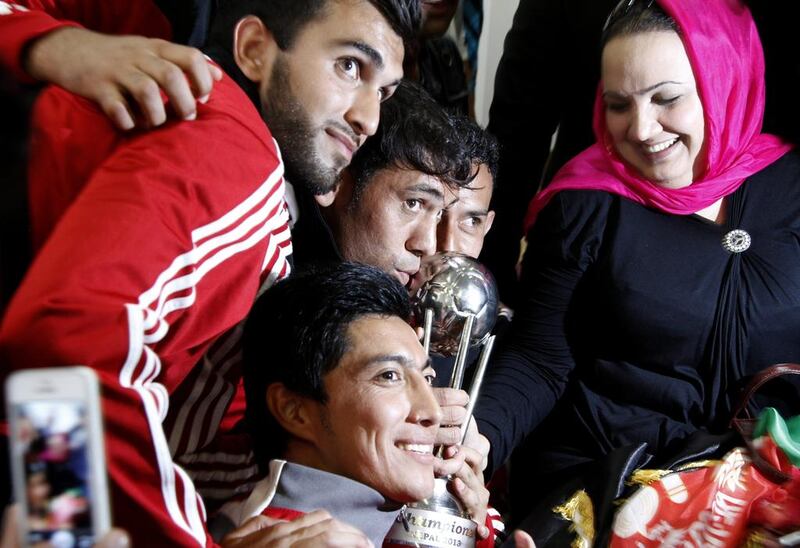 Members of the Afghan national football team pose for a photograph on their return to Kabul. Ahmad Jamshid / AP Photo
