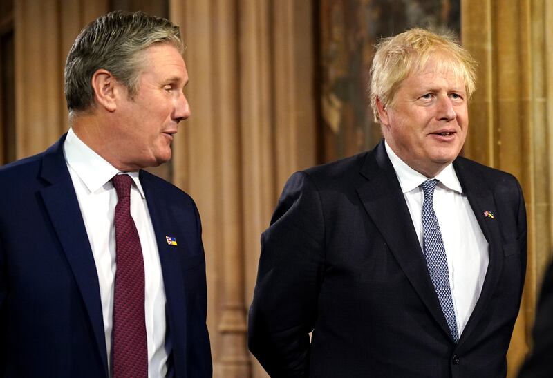 Mr Johnson and Mr Starmer speak in the Central Lobby at the Palace of Westminster. PA