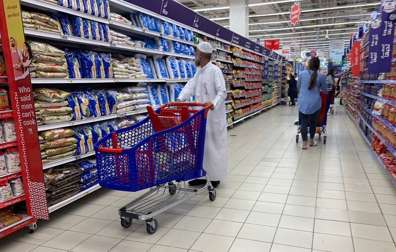 Shoppers check rice products at the Carrefour hypermarket at Mall of the Emirates in Dubai. Pawan Singh / The National 