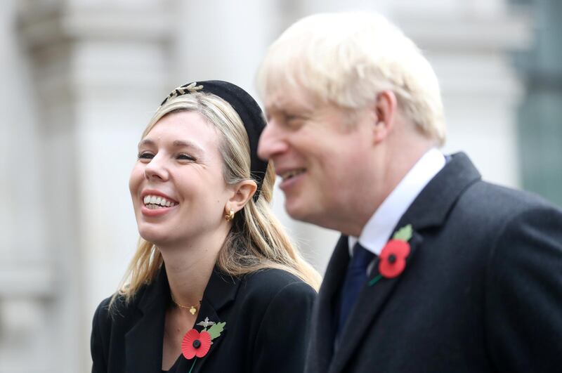 LONDON, ENGLAND - NOVEMBER 08: Britain's Prime Minister Boris Johnson with partner Carrie Symonds, meet veterans during the National Service of Remembrance at The Cenotaph on November 08, 2020 in London, England. Remembrance Sunday services are still able to go ahead despite the covid-19 measures in place across the various nations of the UK. Each country has issued guidelines to ensure the safety of those taking part. (Photo by Chris Jackson - WPA Pool/Getty Images)