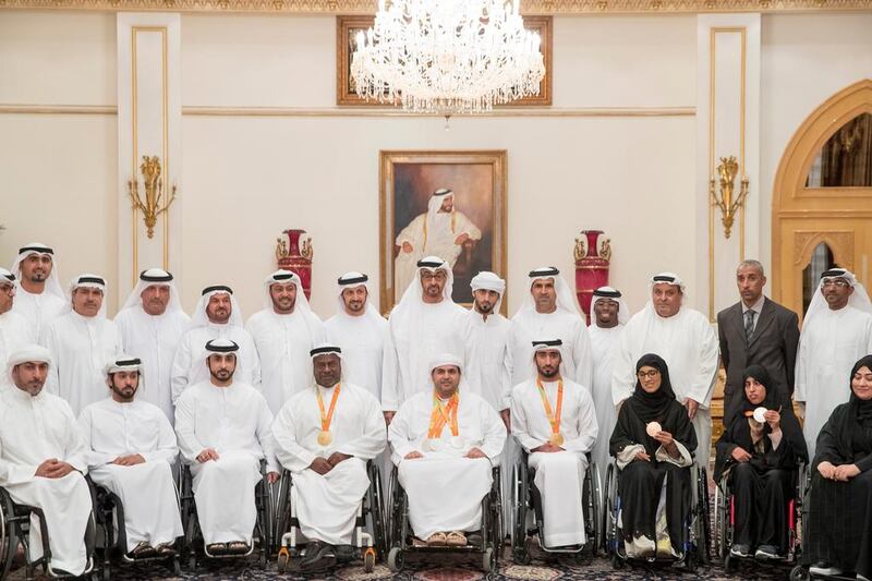 Sheikh Mohammed bin Zayed with members of the Paralympic team. With them is Mohamed Fadel Al Hameli, Chairman of the UAE Disabled Sports Federation (back row, fifth right).