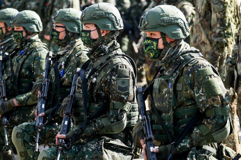 Members of Taiwan's armed forces wear protective masks during a military exercise in Hukou, Hsinchu County, Taiwan, on Tuesday, Jan. 19, 2021. China's state-run media called for retaliation after the Trump administration removed decades-old restrictions on interactions with Taiwan officials just days before President-elect Joe Biden takes office, one of its biggest moves yet to reshape U.S. ties with the Asian democracy. Photographer: I-Hwa Cheng/Bloomberg