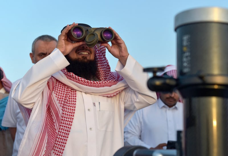 A man looks for the first crescent moon in the Saudi city of Taif, in April 2022. AFP