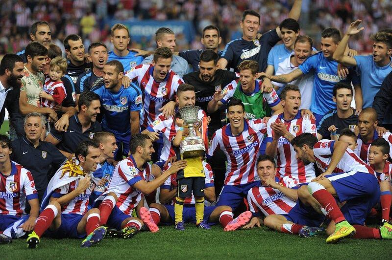 Atletico Madrid players celebrate after beating Real Madrid 1-0 (2-1) on aggregate to win the Spanish Supercopa at the Vicente Caldron on Friday. Denis Doyle / Getty Images