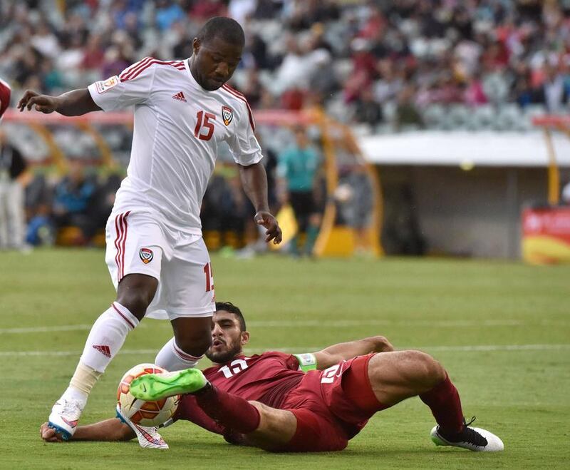 Ismail Al Hammadi of the UAE fights for the ball with Ibrahim Majed of Qatar during the Asian Cup football match between UAE and Qatar in Canberra on January 11, 2015. AFP