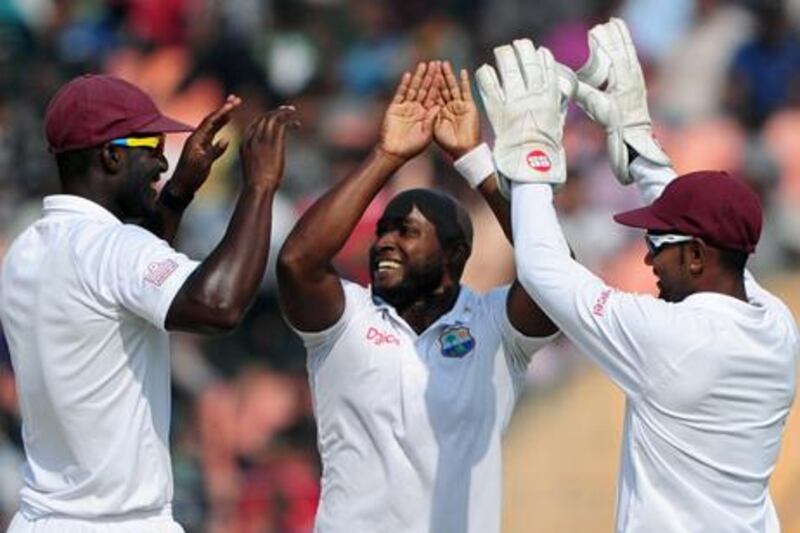 Tino Best celebrates with Darren Sammy and Denesh Ramdin after taking another wicket against Bangladesh
