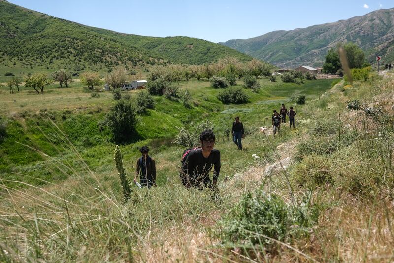 Afghan refugees walk near Tatvan district in Bitlis city eastern province of Turkey.