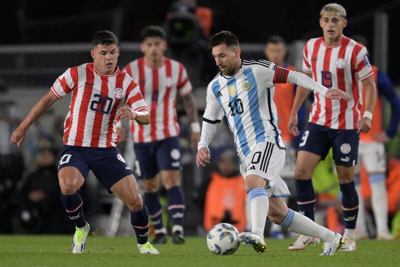 Argentina forward Lionel Messi and Paraguay midfielder Richard Sanchez vie for the ball. AFP