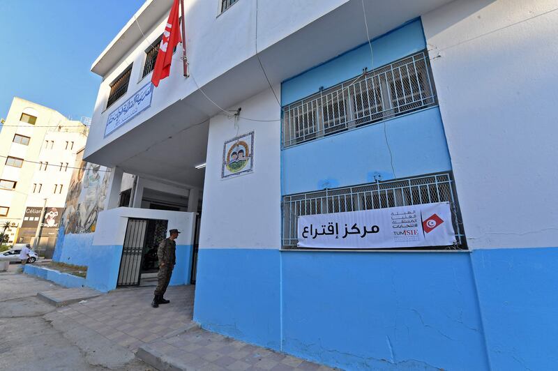 A member of Tunisian security forces stands guard outside a polling station in Ariana district of Tunis. AFP