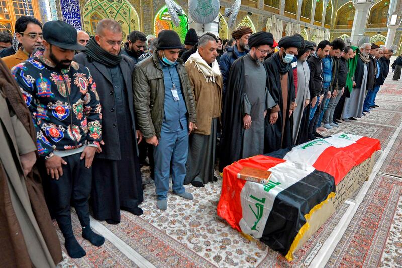 Mourners pray over the coffin of a victim who was killed in a twin suicide bombing in central Baghdad, during a funeral in the holy city of Najaf, Iraq.  AFP