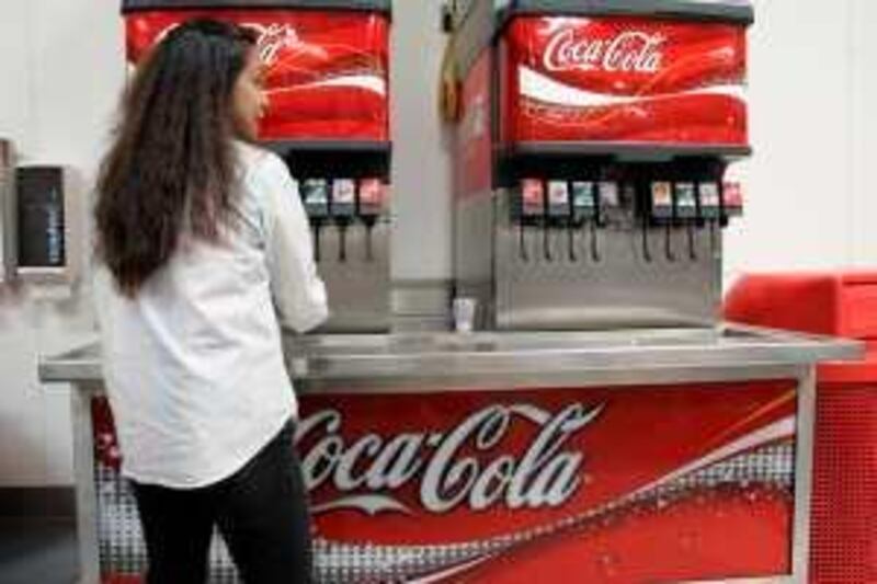 A Costco customer fills a cup with Coca-Cola at Costco in Mountain View, Calif., Wednesday, May 28, 2008. Soft drink bottler Coca-Cola Enterprises Inc. said Wednesday weak sales trends in the U.S especially on some 20-ounce beverages will likely lead to a decline in its second quarter earnings and may make it difficult to meet its 2008 profit guidance. (AP Photo/Paul Sakuma)