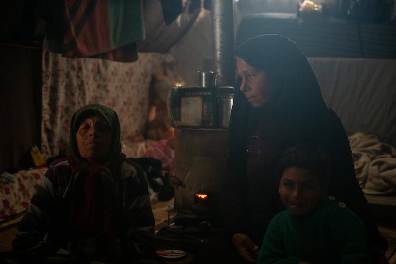 Ms Sido, with family members in their tent in Jindires. Seven people live there, she said, three of whom have permanent disabilities