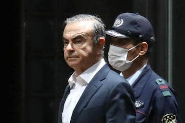 Former Nissan chairman Carlos Ghosn being escorted as he walks out of the Tokyo Detention House following his release on bail in Tokyo, Japan. AFP