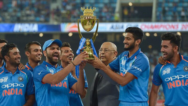 Indian Cricket team captain Rohit Sharma (3L) and team celebrates after won during the final one day international (ODI) Asia Cup cricket match between Bangladesh and India at the Dubai International Cricket Stadium in Dubai on September 28, 2018. / AFP / ISHARA S. KODIKARA
