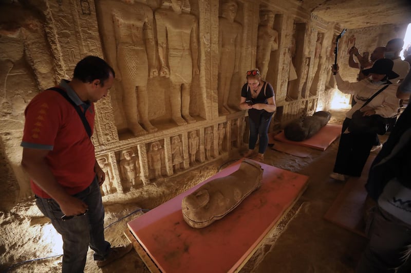 People inspect the sarcophagus on display after they were discovered at Saqqara Necropolis, Giza.  EPA