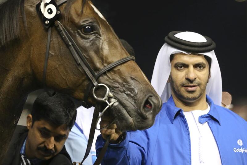 Saeed bin Suroor, the trainer of Be Ready, poses with Songcraft, ridden by Silvestre De Sousa and owned by Godolphin, after it won the Ford Edge Sport Trophy at Meydan Racecourse on February 13, 2014. Razan Alzayani / The National