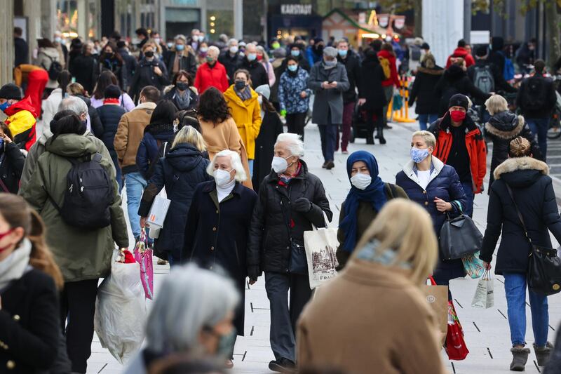 Shoppers wear protective face masks on a crowded retail high street in Frankfurt, Germany. Bloomberg