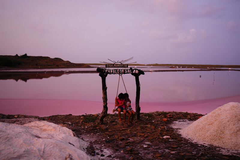 Children play near the salt flat of Pampatar on Margarita Island, Venezuela. AP