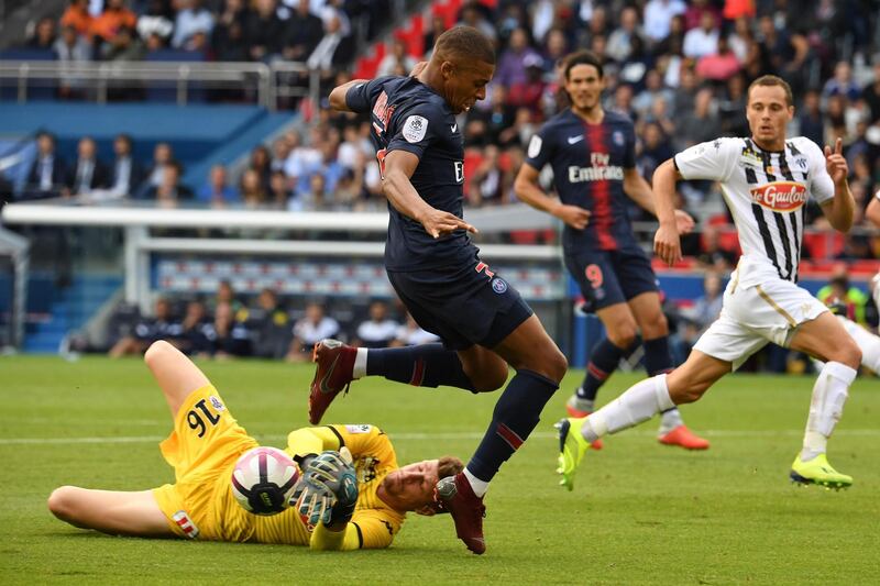 Angers' goalkeeper Ludovic Butelle makes a save in front of Mbappe. AFP
