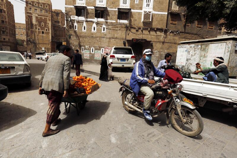 epa06566910 Yemenis walk through an alley in the old quarter of Sana'a, Yemen, 26 February 2018. According to reports, the UN Security Council was considering two draft resolutions on Yemen after Russia put forward a rival text aimed at blocking action against Iran over missiles sent to the country's Houthi rebels. The council is set to vote 26 February on renewing sanctions on Yemen for a year.  EPA/YAHYA ARHAB
