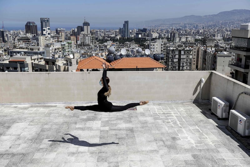 Sherazade Mami, a 28-year-old Tunisian professional dancer and performer at the Caracalla dance theatre and a teacher at the Caracalla dance school, practises while wearing a surgical mask on the roof of her apartment building in the suburb of Dekwaneh on the eastern outskirts of Lebanon's capital Beirut. AFP