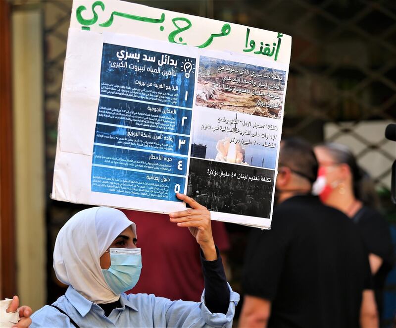 Anti-government protesters carry placards and shout slogans against the Bisri Dam in front of the World Bank office in central Beirut, Lebanon. EPA