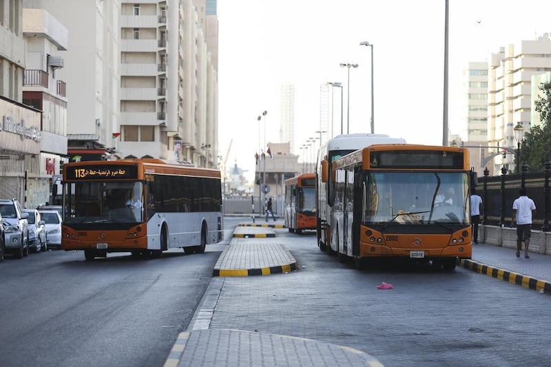 Buses queue at Rolla bus station in Sharjah, where illegal taxi touts and drivers also do a roaring trade. Sarah Dea / The National