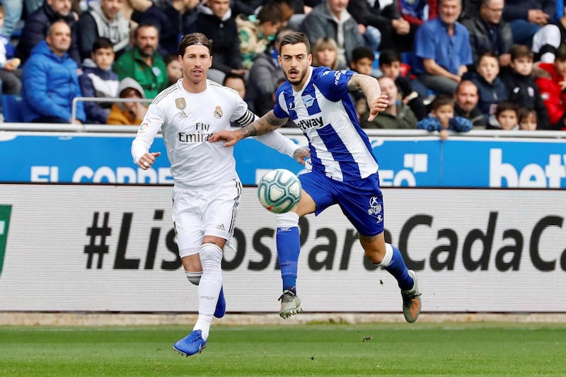 Real Madrid's Sergio Ramos (L) vies for the ball with Alaves' Joselu. EPA